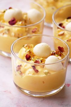 three desserts in small glass dishes on a table