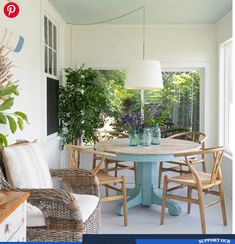 a table and chairs in a room with plants