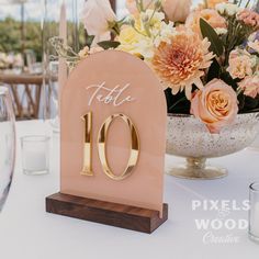 the table numbers are set up in front of an elegant centerpiece with flowers and candles