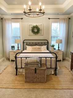 a bed room with a neatly made bed and a basket on the floor next to it