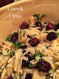 pasta with olives and parmesan cheese in a yellow bowl