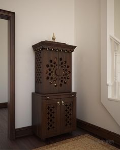 a tall wooden cabinet sitting on top of a hard wood floor