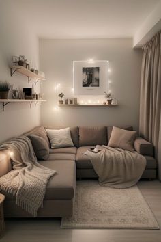 a living room with a sectional couch and pillows on the floor, lights in the corner