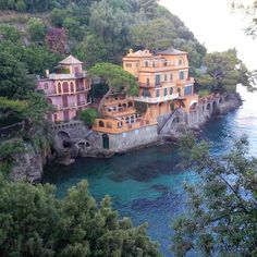 the houses on the cliff have been built into the water and are surrounded by greenery