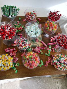 a table topped with lots of candy covered candies and lollipops on top of each other