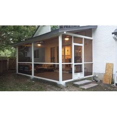 a screened in porch with sliding glass doors on the front and back side of it