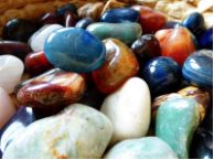 a basket filled with lots of different colored rocks