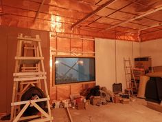 a room that is under construction with some items on the floor and in front of it