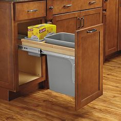 a kitchen with wooden cabinets and an open dishwasher in the center, on top of a hard wood floor