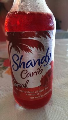 a bottle of liquid sitting on top of a table next to a white cloth covered tablecloth