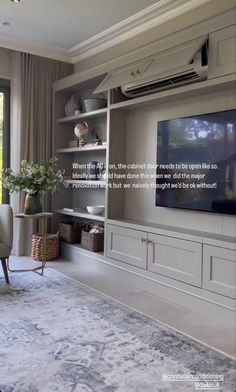 a living room filled with furniture and a flat screen tv on top of a wall