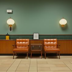 two brown leather chairs sitting next to each other in a room with tile flooring