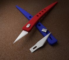 two red and blue scissors are on the table