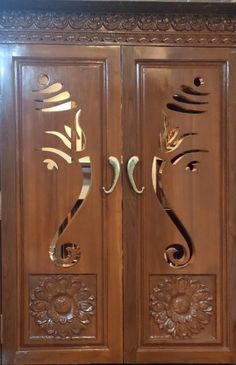 an ornate wooden door with decorative carvings on it