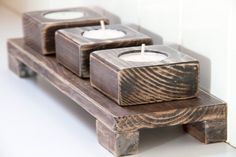 three wooden candles sitting on top of each other