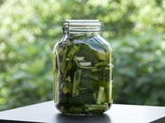 a jar filled with pickles sitting on top of a table