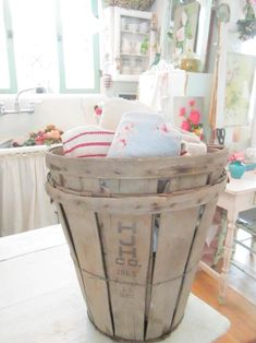 an old wooden basket is sitting on top of a table