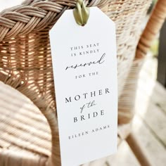 a white tag that says, this seat is kindly reserved for the mother of the bride