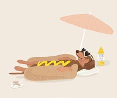 a hot dog with mustard and ketchup on the beach next to an umbrella