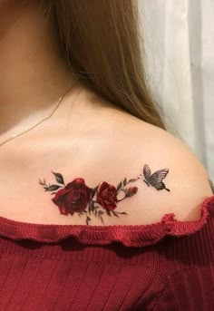 a woman's shoulder with roses and a butterfly tattoo on her left side chest