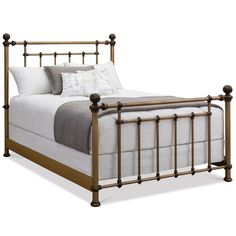 a metal bed frame with white sheets and pillows on it's headboard, in front of a white background