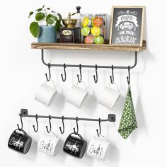 coffee mugs are hanging on the wall with hooks