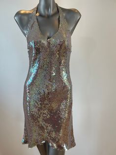 A unique opportunity to own a beautiful Vintage Caroline Holmes Couture Gown at just 10% of it's original value from our Knightsbridge Salon.  The Gown is handmade from the finest silks, silk lined to create that extra special feeling of elegance to it's wearer. Description: Silver/multi color sequin halter-neck mini gown with tapered hemline. Back concealed zipper. Speciality Jacob Schlapfer fabric. Sequins sewn onto silk chiffon. Silk satin lined. UK size  10-12 Measurements: Bust 34" Waist  2 Halter Neck Mini Dress With Contrast Sequin, Evening V-neck Mini Dress With Contrast Sequin, Silver Embellished V-neck Mini Dress, Silver Shimmer V-neck Mini Dress, H&m Silver Sequin Dress, Mini Gown, Silver Sequin Dress, Sequin Halter, Couture Gowns