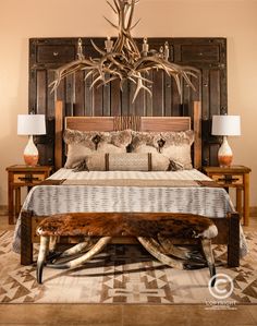 a bed with antlers on the headboard and foot board