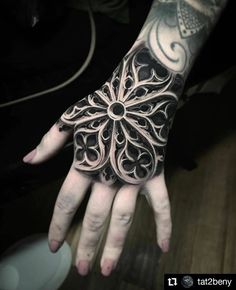 a person's hand with an intricate design on it