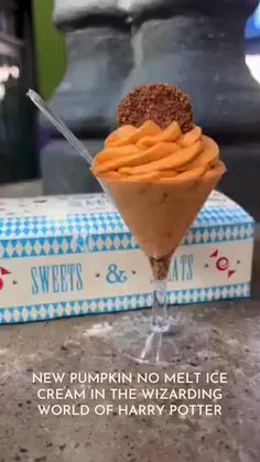 an ice cream sundae with chocolate sprinkles in a glass on top of a box