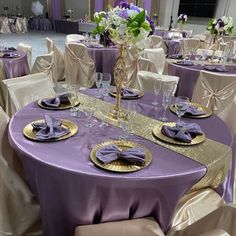 the table is set with purple and gold linens