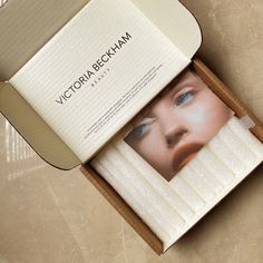 an open box with a photograph of a woman's face on it