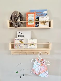 two wooden shelves holding books and stuffed animals