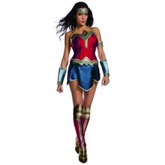 a woman dressed as wonder is walking down the street with her hands on her hips