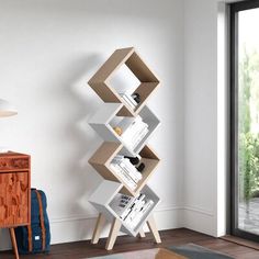 a modern bookcase in the corner of a living room