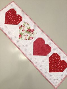 a red and white table runner with hearts on it