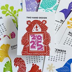 several calendars with different designs and numbers on them, including two hand design bears