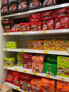 the shelves are filled with many different types of snacks