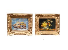 two framed paintings depicting ships in the ocean and flowers on display with gold framers