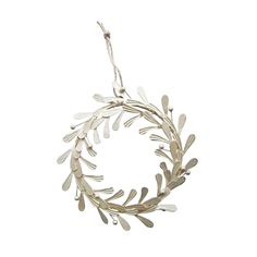 a silver wreath with leaves hanging from it