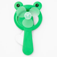 a green frog shaped toothbrush with a white background