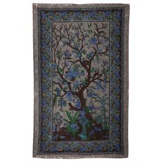 a tree with blue flowers and birds on it is hanging from the side of a wall