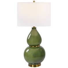 a green table lamp with a white shade