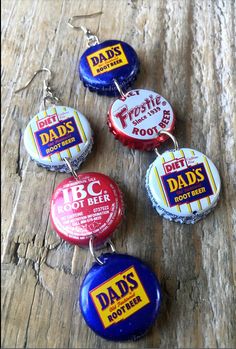 six beer bottle caps with the words dad's root beer on them sitting on top of a wooden table