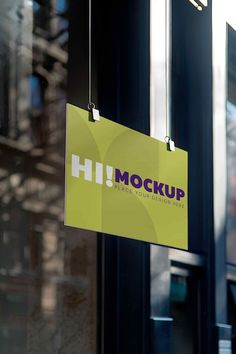 a sign hanging from the side of a building that says hi mock up next to it