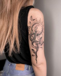 a woman with a snake tattoo on her arm