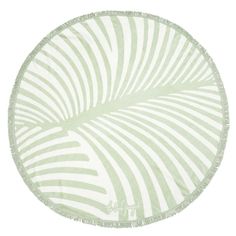 a round green and white rug with an abstract design