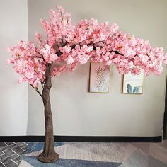 a tree with pink flowers in a room