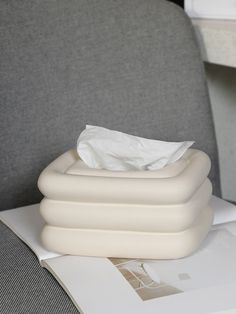 an inflatable mattress sitting on top of a table next to a piece of paper