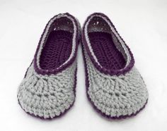 two crocheted slippers sitting on top of a white surface